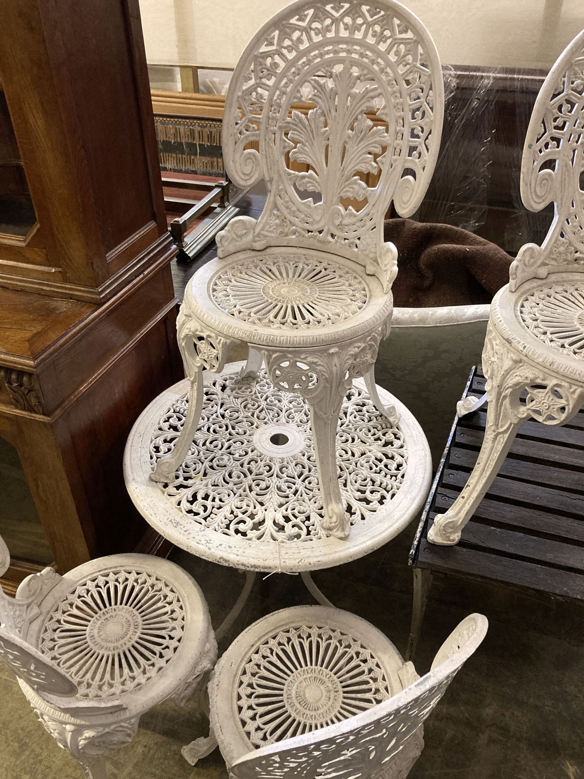 A Victorian style painted aluminium circular garden table, 69cm diameter together with a set of four similar chairs